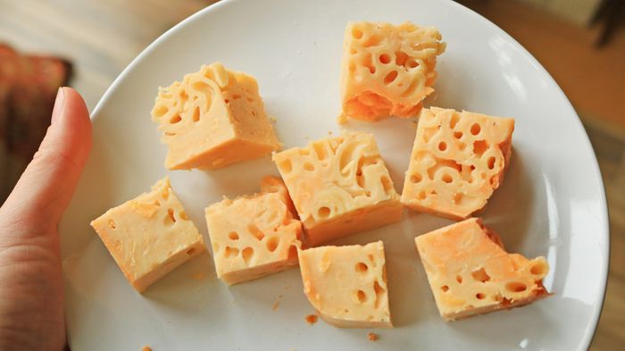 Chopped mac and cheese squares neatly arranged on a plate.