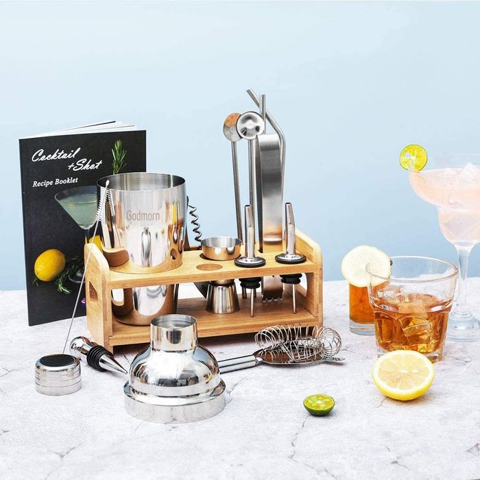 The bartending kit, complete with stand, and a variety of mixed drinks ready to be served.