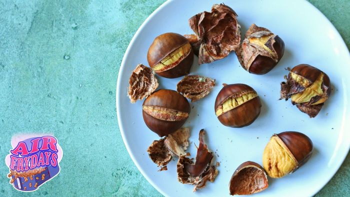 A plate filled with perfectly roasted chestnuts.