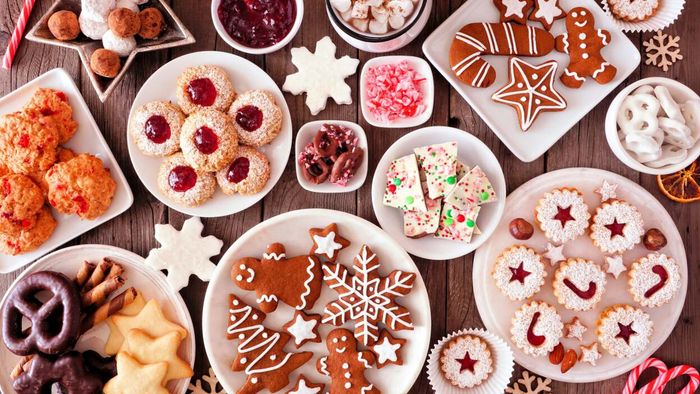 An array of festive holiday cookies lined up on a table.