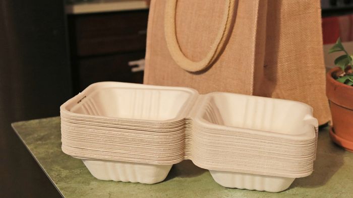 Takeout containers placed next to a bag.