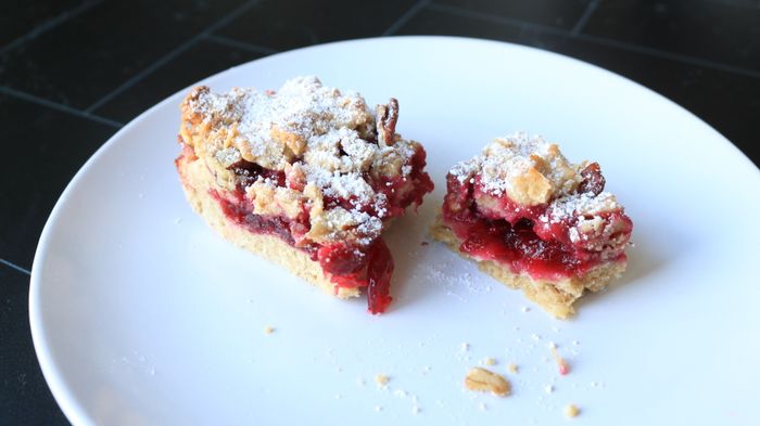 A jam bar, cracked and resting on a plate, waiting to be devoured.