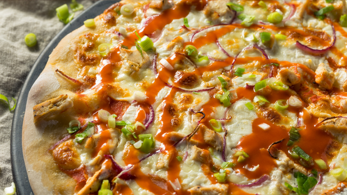 A pizza topped with tangy buffalo sauce