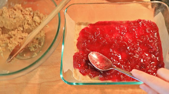 Spread spoonfuls of cranberry sauce onto the cookie bars.