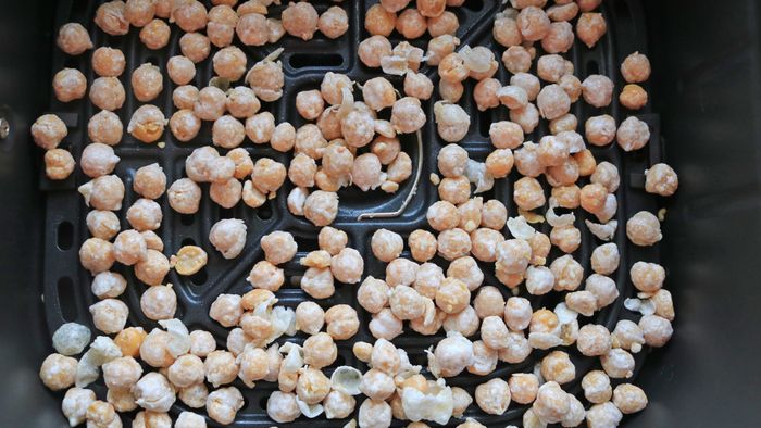 Chickpeas placed inside the air fryer basket.