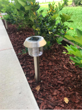 The solar lights along the walkway during the day.