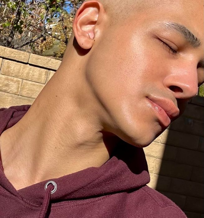 A close-up shot of a reviewer with radiant, glowing skin