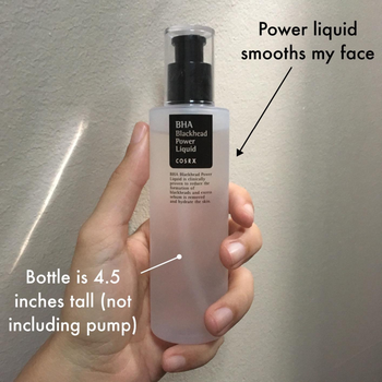 A hand holding a 4.5-inch bottle of COSRX BHA Blackhead Power Liquid, with text emphasizing its skin-smoothing properties