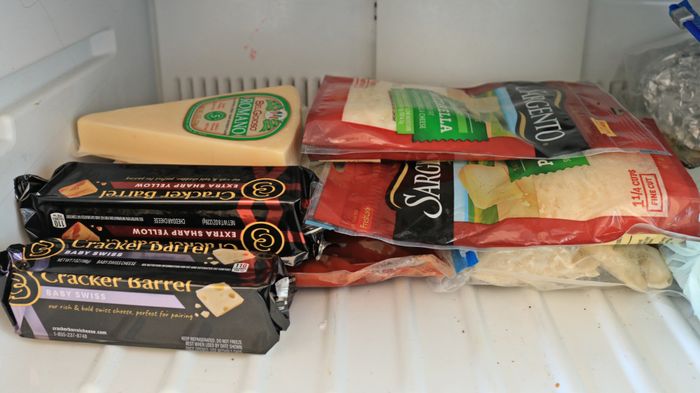 Cheese blocks and bags stored in the freezer.