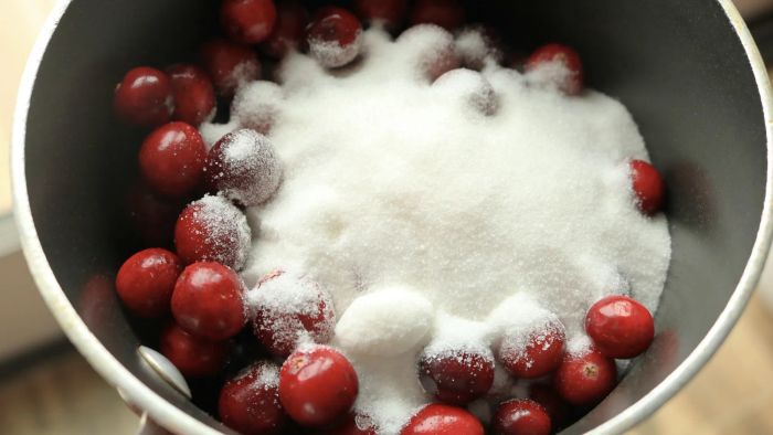 Place cranberries and sugar in a saucepan.