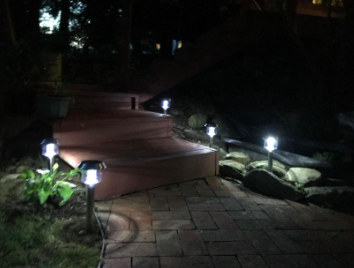 The solar lights glowing at night along a path.