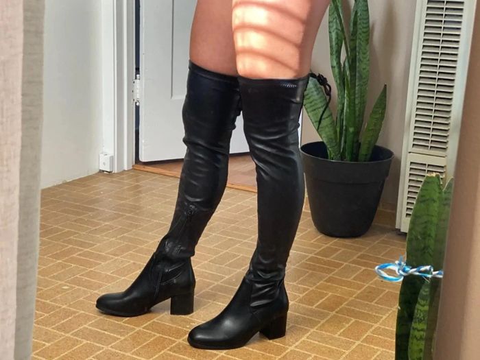 A reviewer sporting black over-the-knee boots