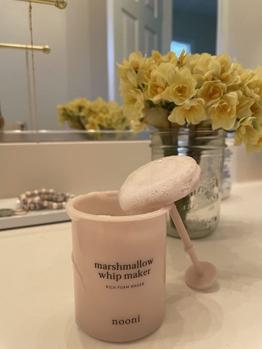 The foam maker, now coated in cleanser, showcasing the smooth, creamy texture it produces.