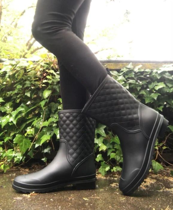 A reviewer confidently wearing the boots.