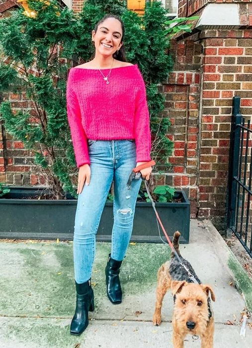 Reviewer styled in boots paired with jeans and a cozy sweater.