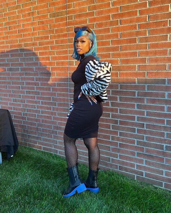 A reviewer styling the boots in black with blue soles