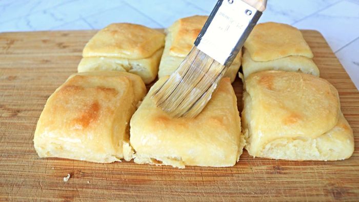 Butter the dinner rolls generously for a rich, smooth finish.