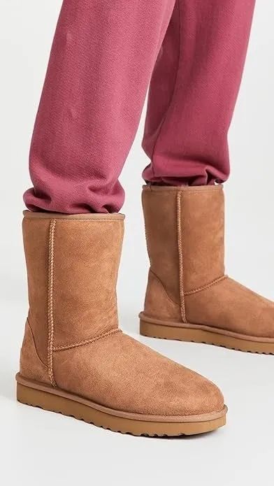 Brown suede boots paired with relaxed, casual red pants, offering a stylish yet comfortable footwear choice