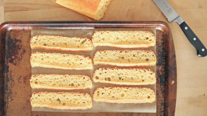 Cornbread slices laid out on a baking tray.