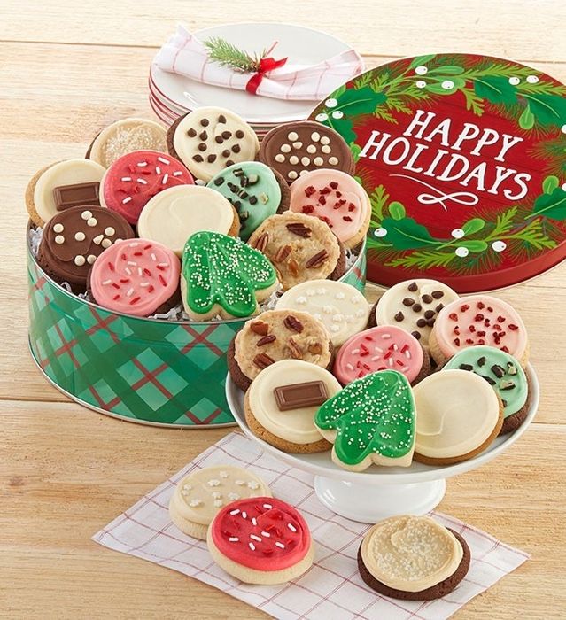 An open cookie tin filled with festive red and green treats.