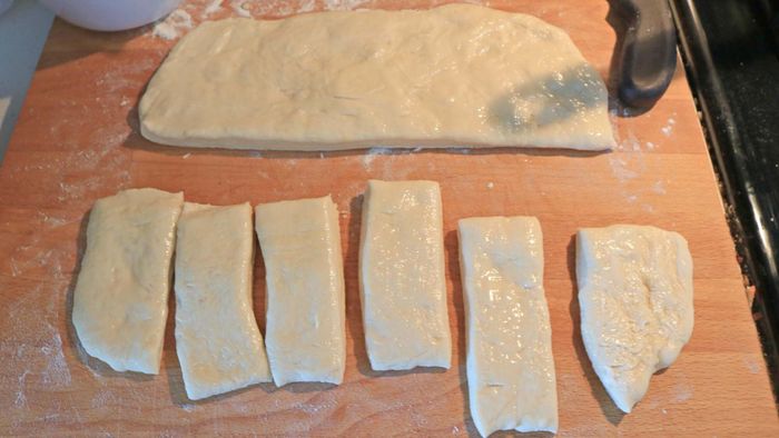 The dough is sliced into rectangles.