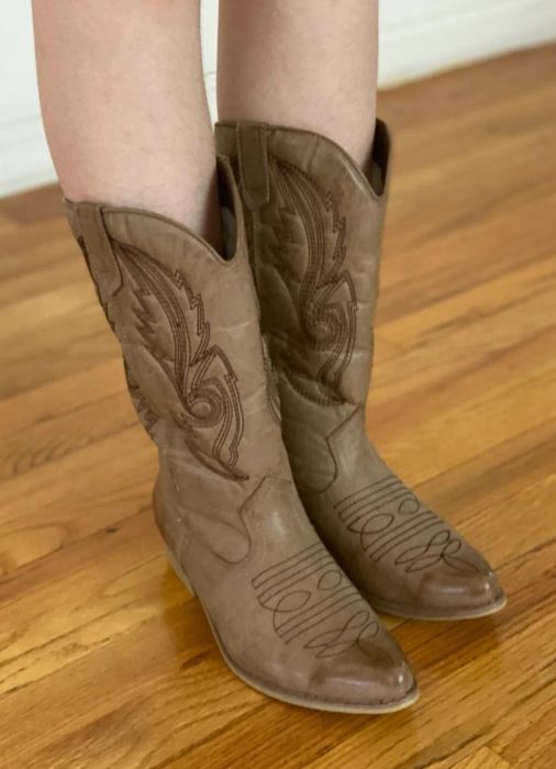 A reviewer styling the cowboy boots in light brown