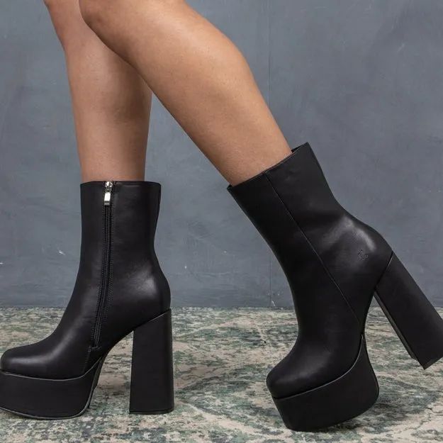 A model confidently rocking the tall platform boots.