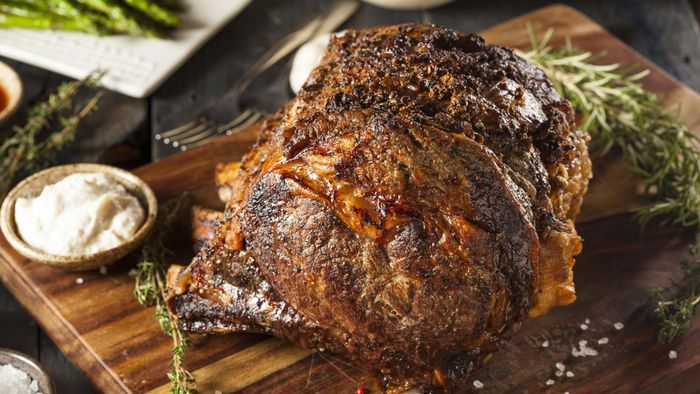 Prime rib roast placed on a cutting board.