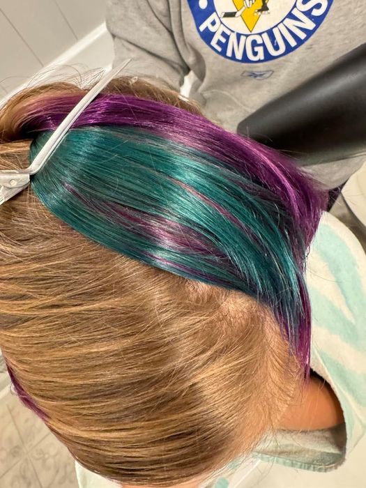 reviewer with streaks of blue and purple in blonde hair