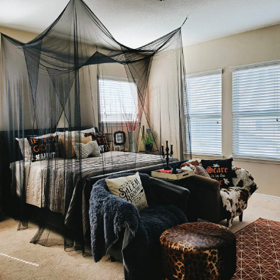 A room with a canopy draped over the entire bed, creating a cozy, enclosed vibe.