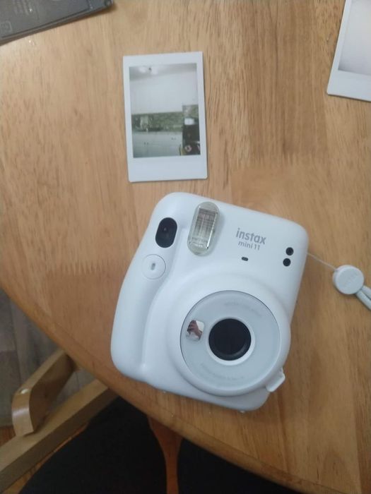 a blue camera with a photo snapped