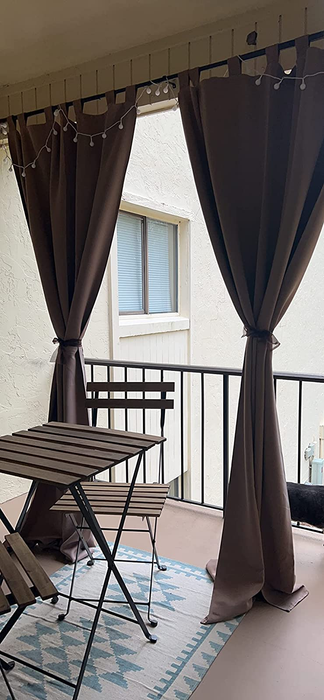 A reviewer's photo showing two curtains tied back on a balcony, giving a neat and polished look