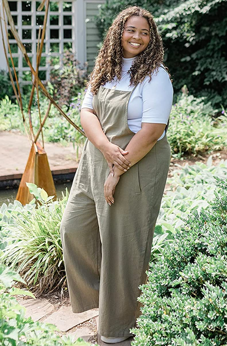 A reviewer sporting a sage green romper over a white top.