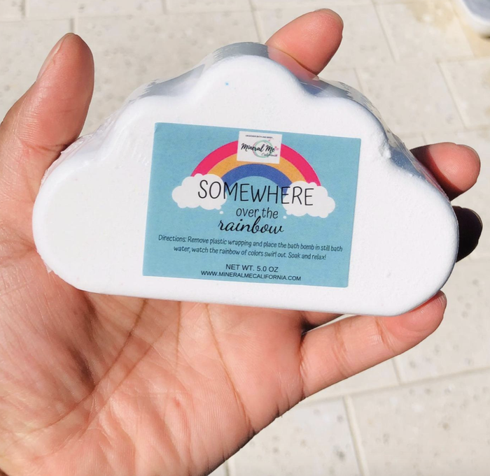 a reviewer holding a cloud-shaped bath bomb in their hands