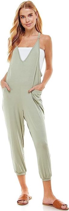 a model showcasing the jumpsuit in sage green