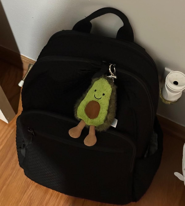 An avocado keychain hanging from the reviewer's backpack.