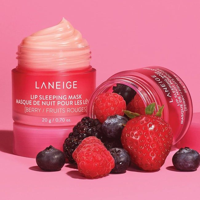 The Laneige Lip Sleeping Mask in a pink jar beside a selection of fresh berries