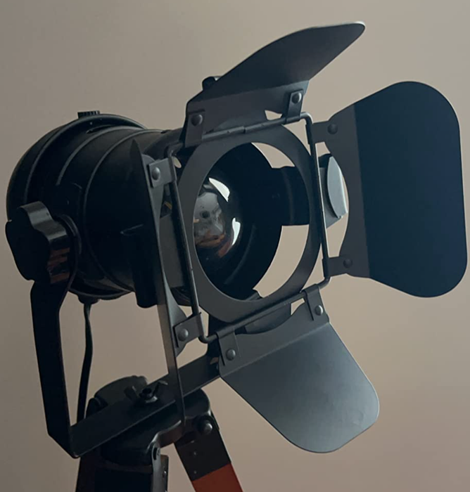 A studio spotlight mounted on a stand, commonly used in professional photography or film productions.