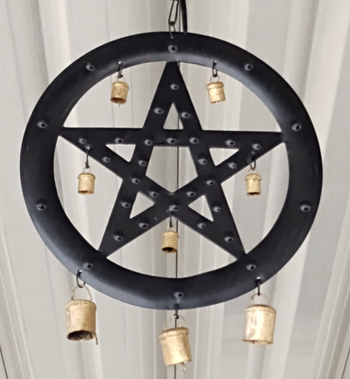 A circular wind chime featuring a pentagram design with hanging bells.