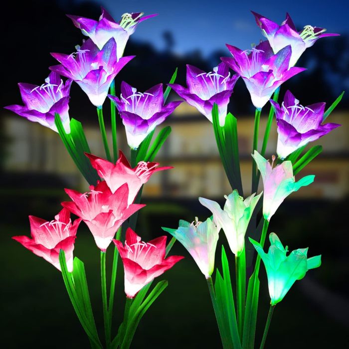 Solar-powered garden lights shaped like vibrant lilies, glowing softly in the night