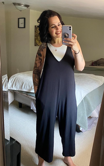 a reviewer modeling the jumpsuit in black