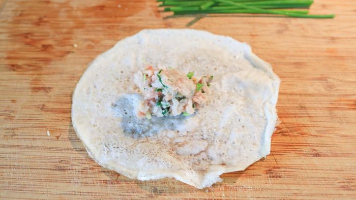 Raw dumpling filling placed on a wrapper.