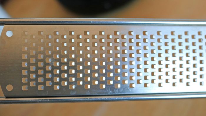 A close-up view of a kitchen rasp showing its small, sharp tines.