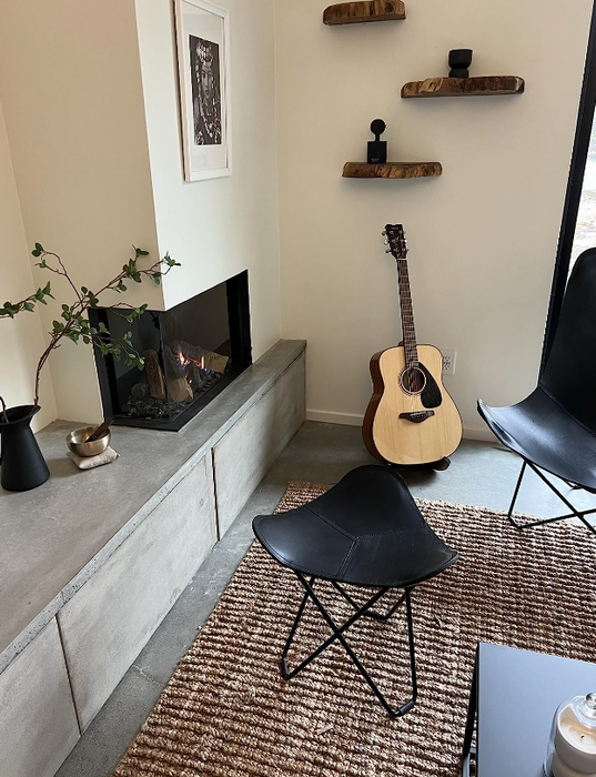 The same reviewer showing the rug in a different room, adding a cozy touch to the space.