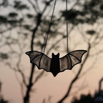 A bat-shaped suncatcher, adding a touch of eerie elegance to any space.