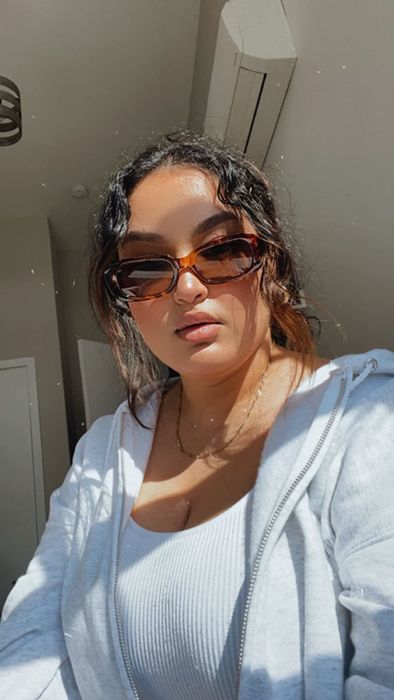 reviewer wearing tortoiseshell sunglasses