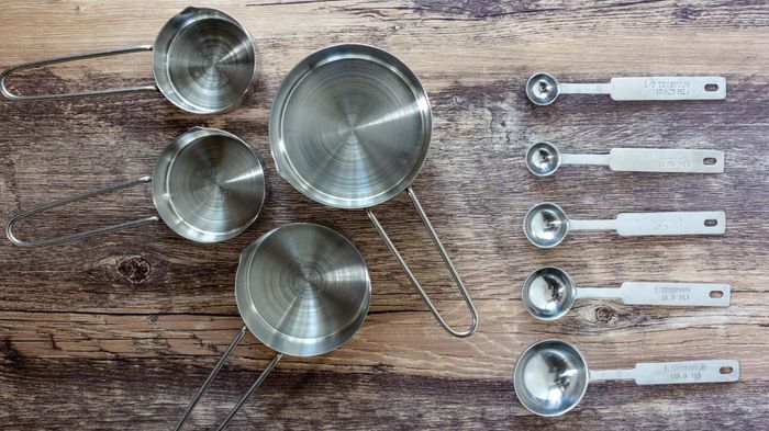 A set of measuring cups and spoons neatly arranged on a table.