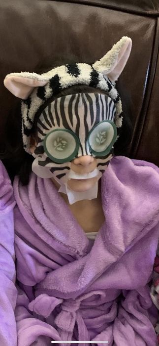 a reviewer wearing a zebra sheet mask
