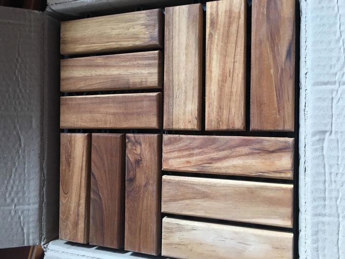 A close-up view of the teak tiles showcasing their texture and finish.