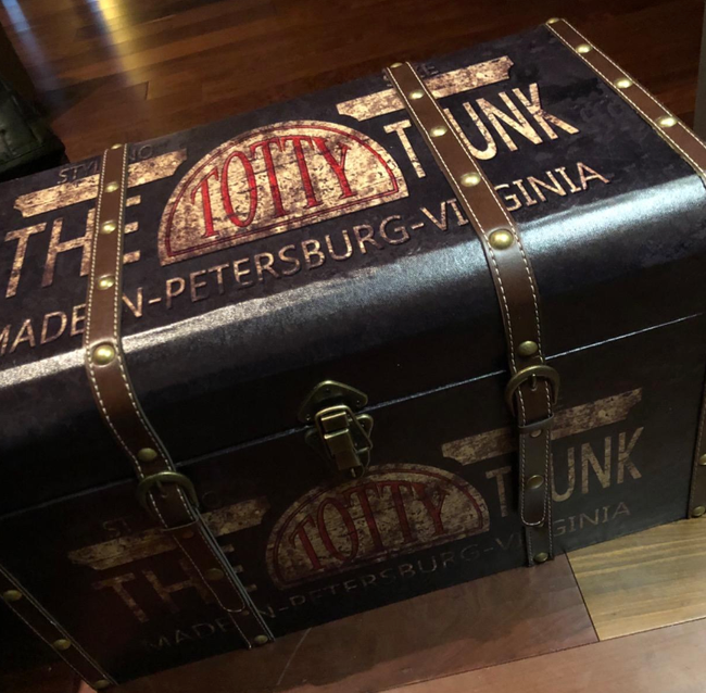 A vintage-style trunk with bold lettering, probably a themed piece or replica that adds personality to your space.